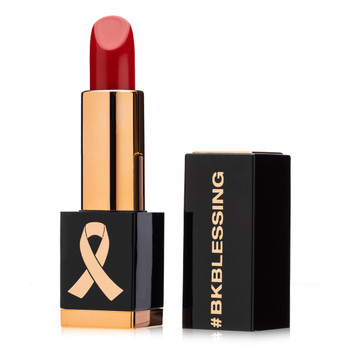 An image of a vivid red lipstick in a #BKBlessing tube with the cap beside it.